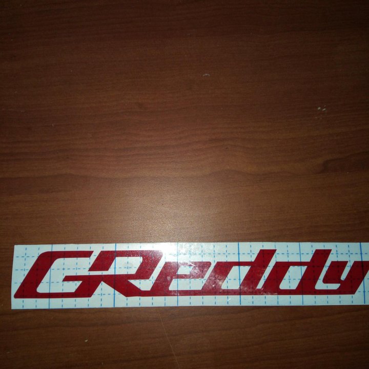 Наклейка на авто GReddy.